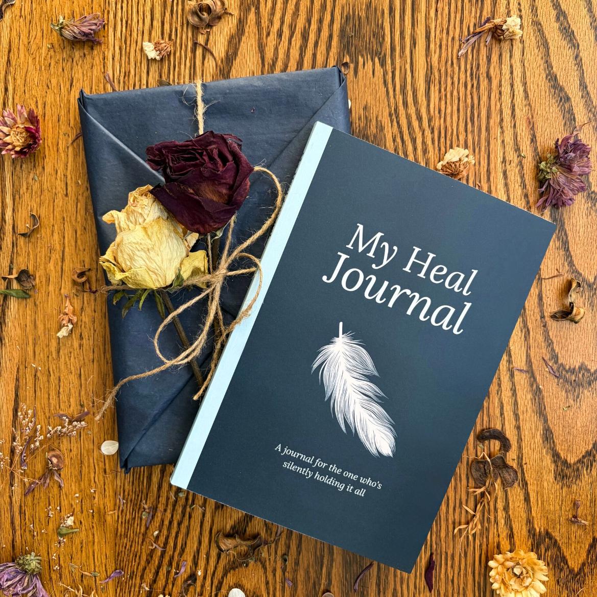 My Heal Journal physical guided healing journal for identity grief and emotional recovery two copies on wooden surface